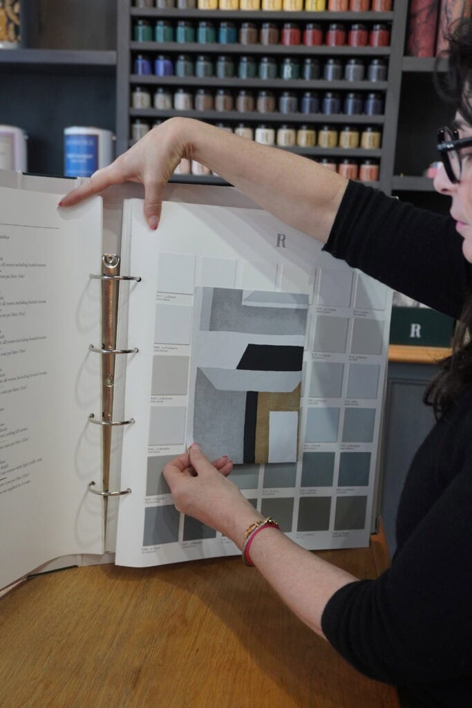 interior decorator working with color swatches, illustrating a professional, intentional approach to color decisions in interior decorating