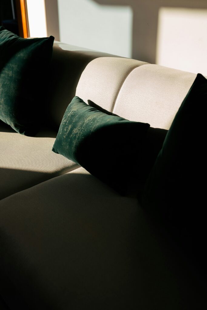 Neutral sofa styled with cushions showing balanced color harmony in interior design